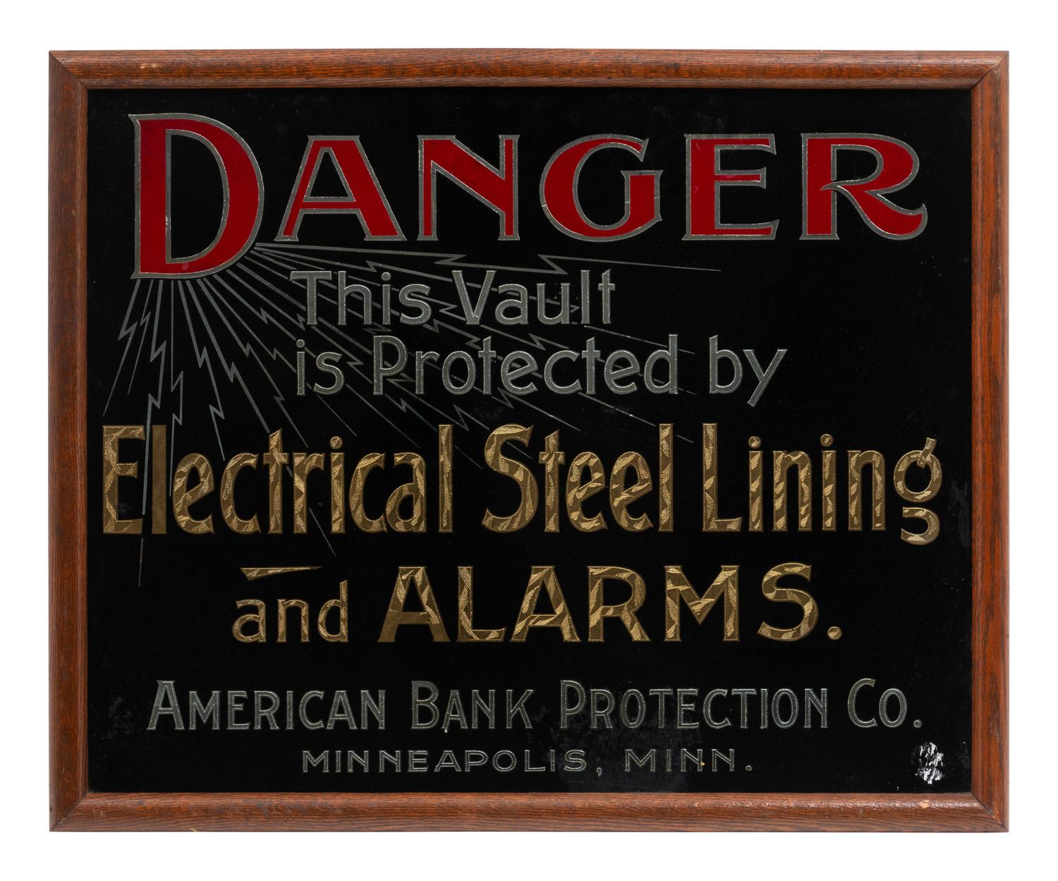 A Parcel Gilt and Reverse Painted Glass American Bank Protection Co. Advertising Sign