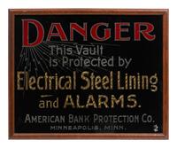 A Parcel Gilt and Reverse Painted Glass American Bank Protection Co. Advertising Sign