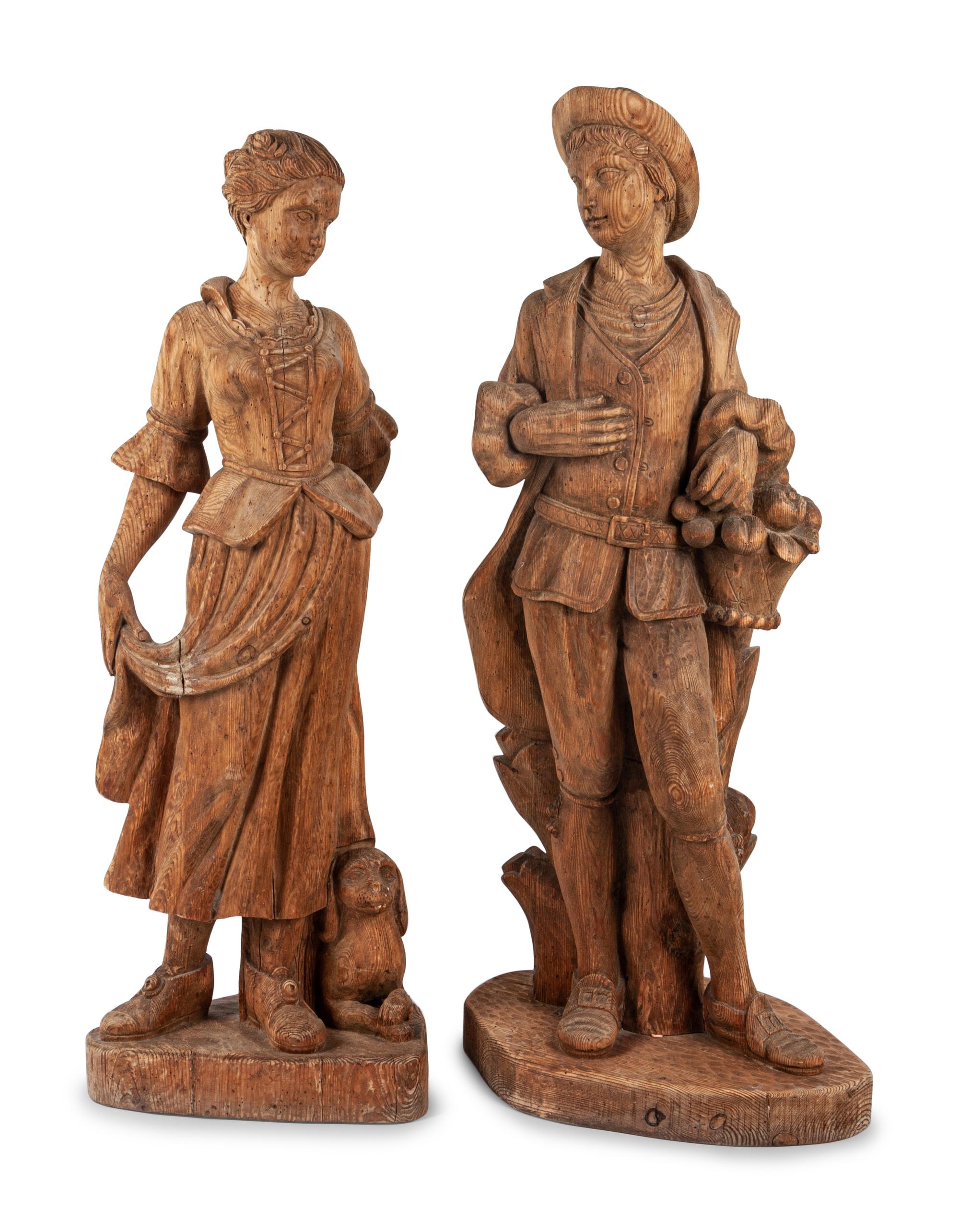 A Pair of Continental Carved Pine Figures