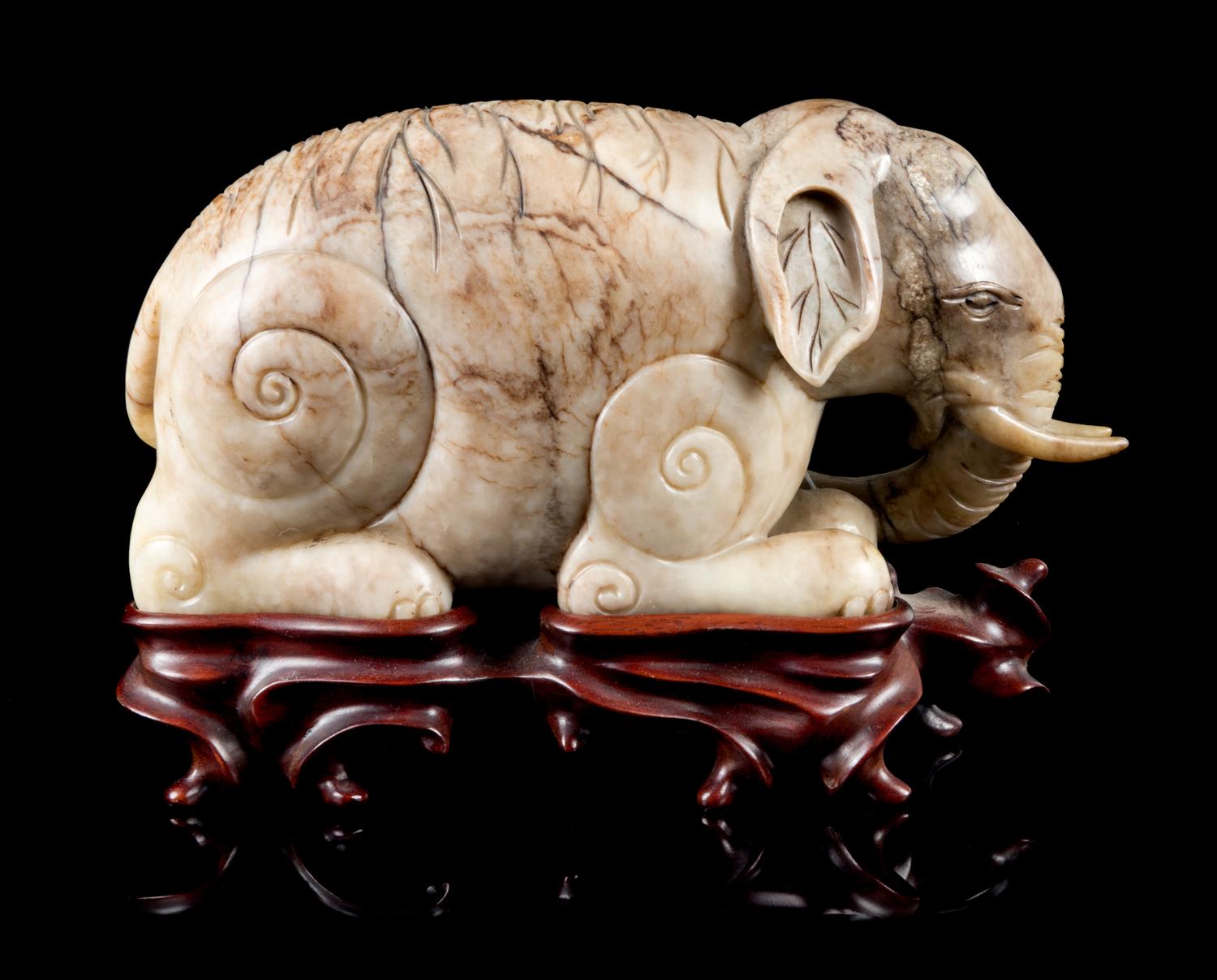 A Mottled Jade Figure of an Elephant Length 7 inches.