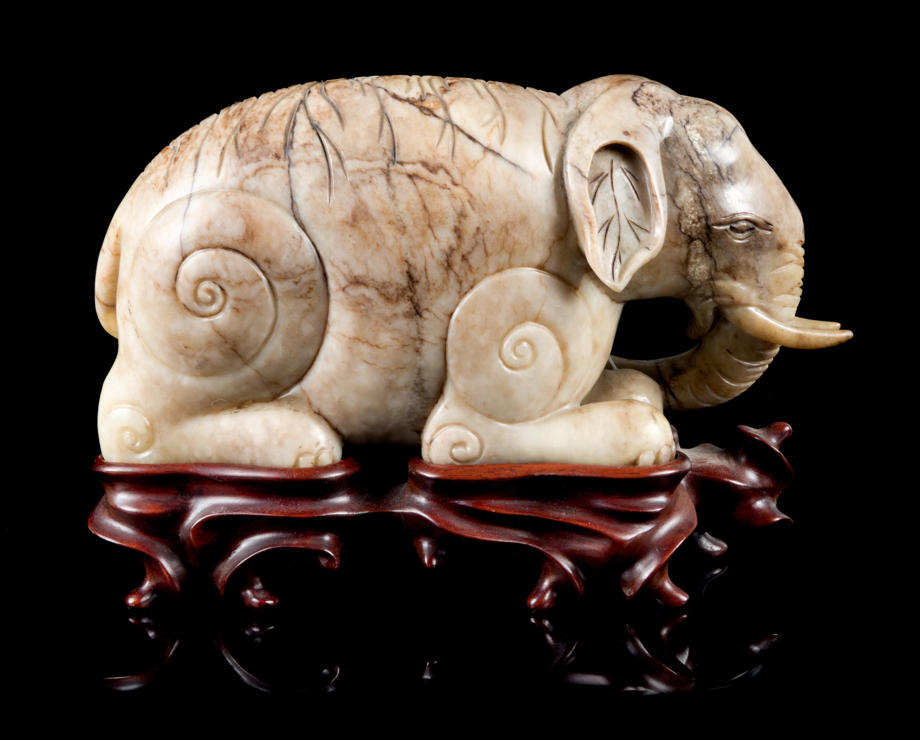 A Mottled Jade Figure of an Elephant Length 7 inches.