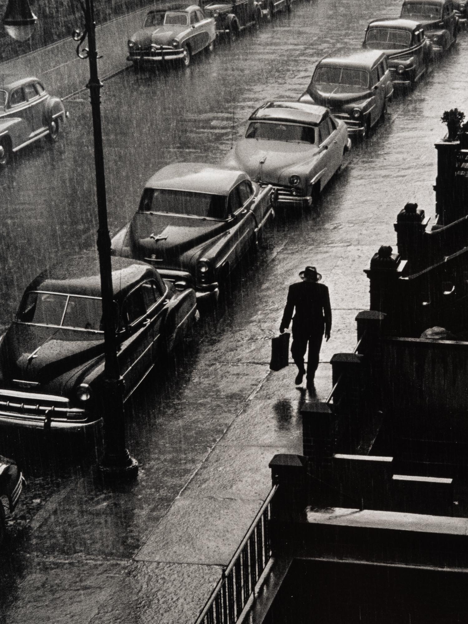 Ruth Orkin (1921-1985) Man in Rain, West 88th Street, New York City, 1952