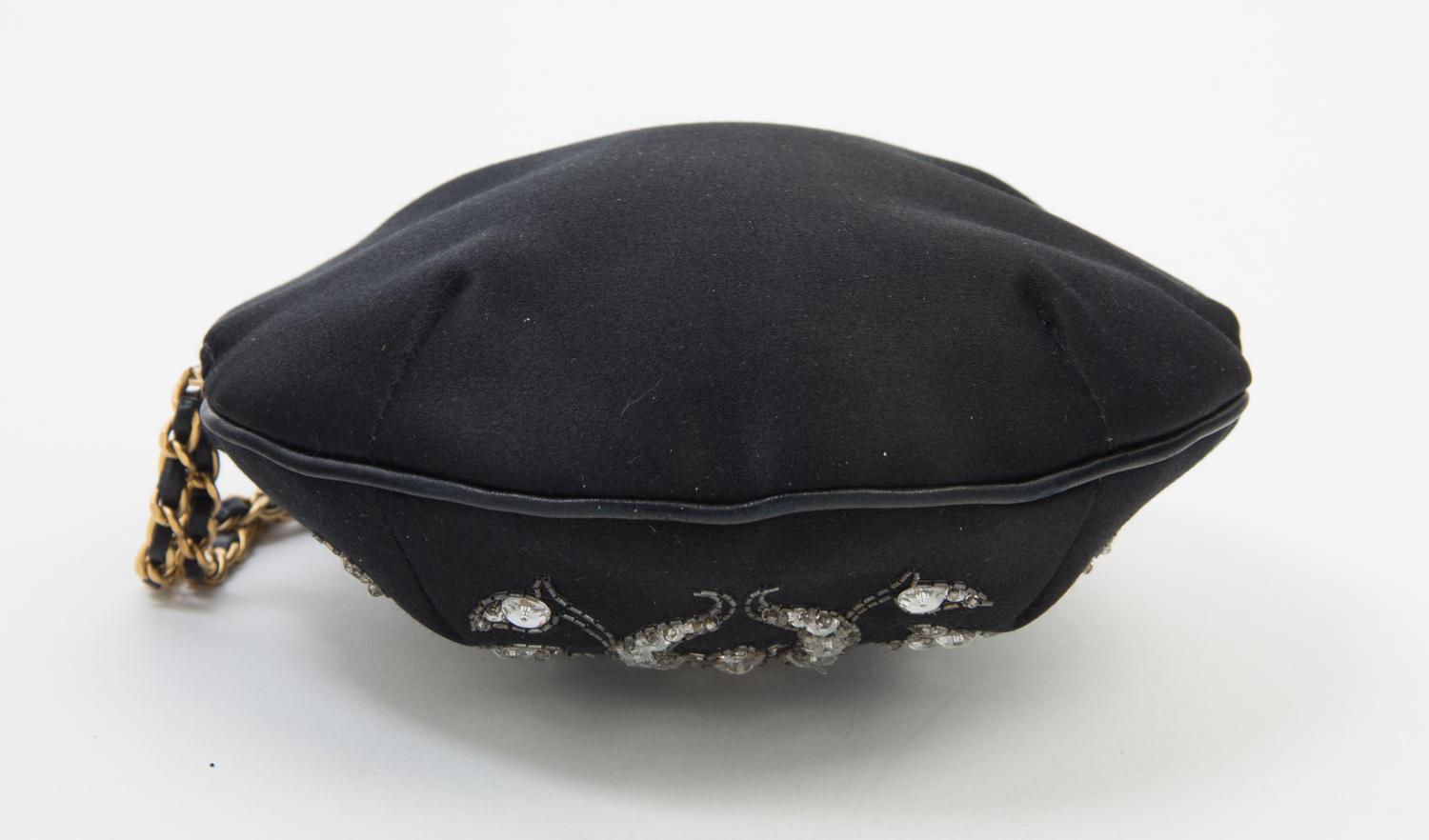 A Chanel Black Silk Embroidered Rhinestone Circular Clutch, 7" diameter.