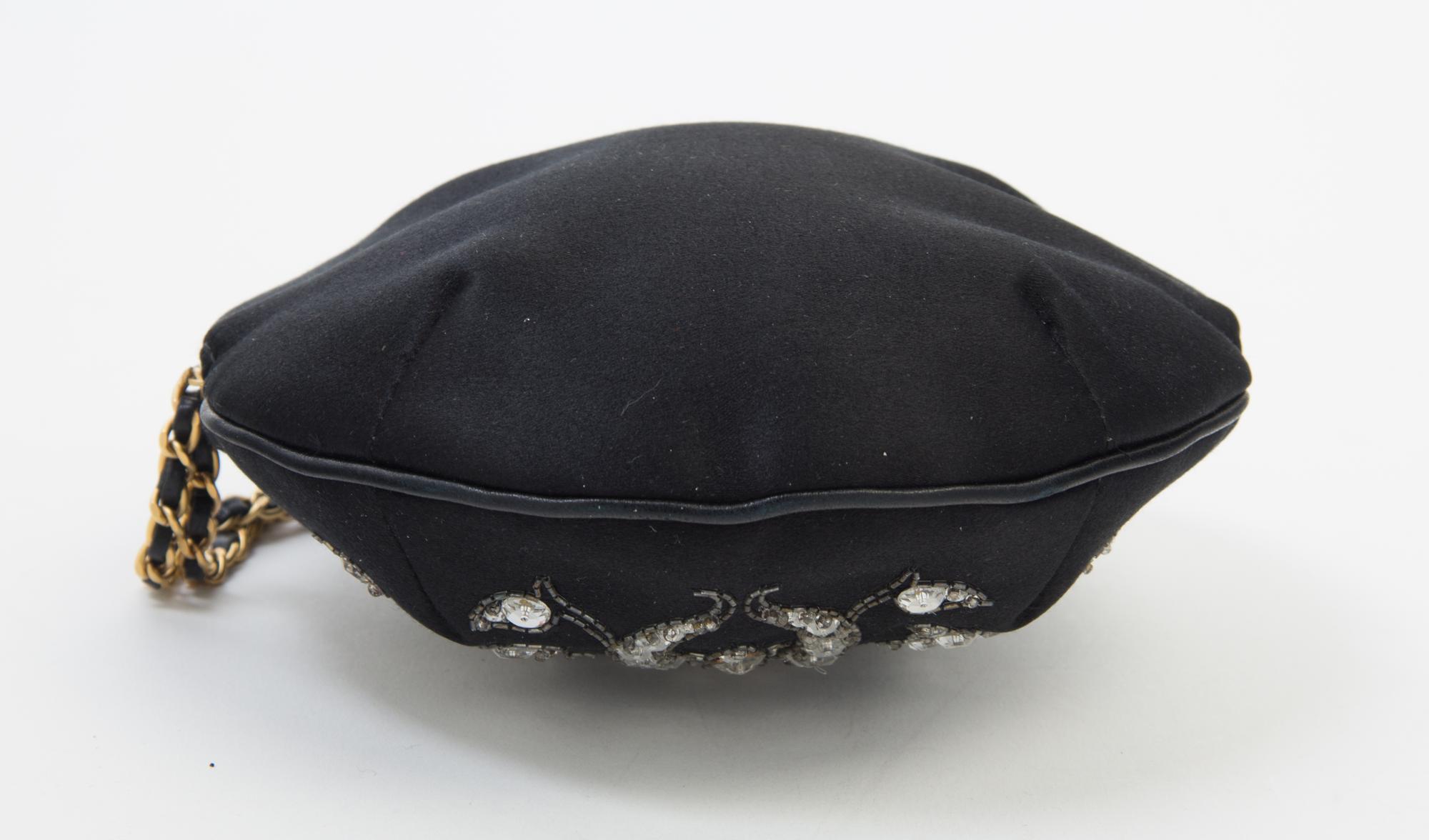 A Chanel Black Silk Embroidered Rhinestone Circular Clutch, 7" diameter.