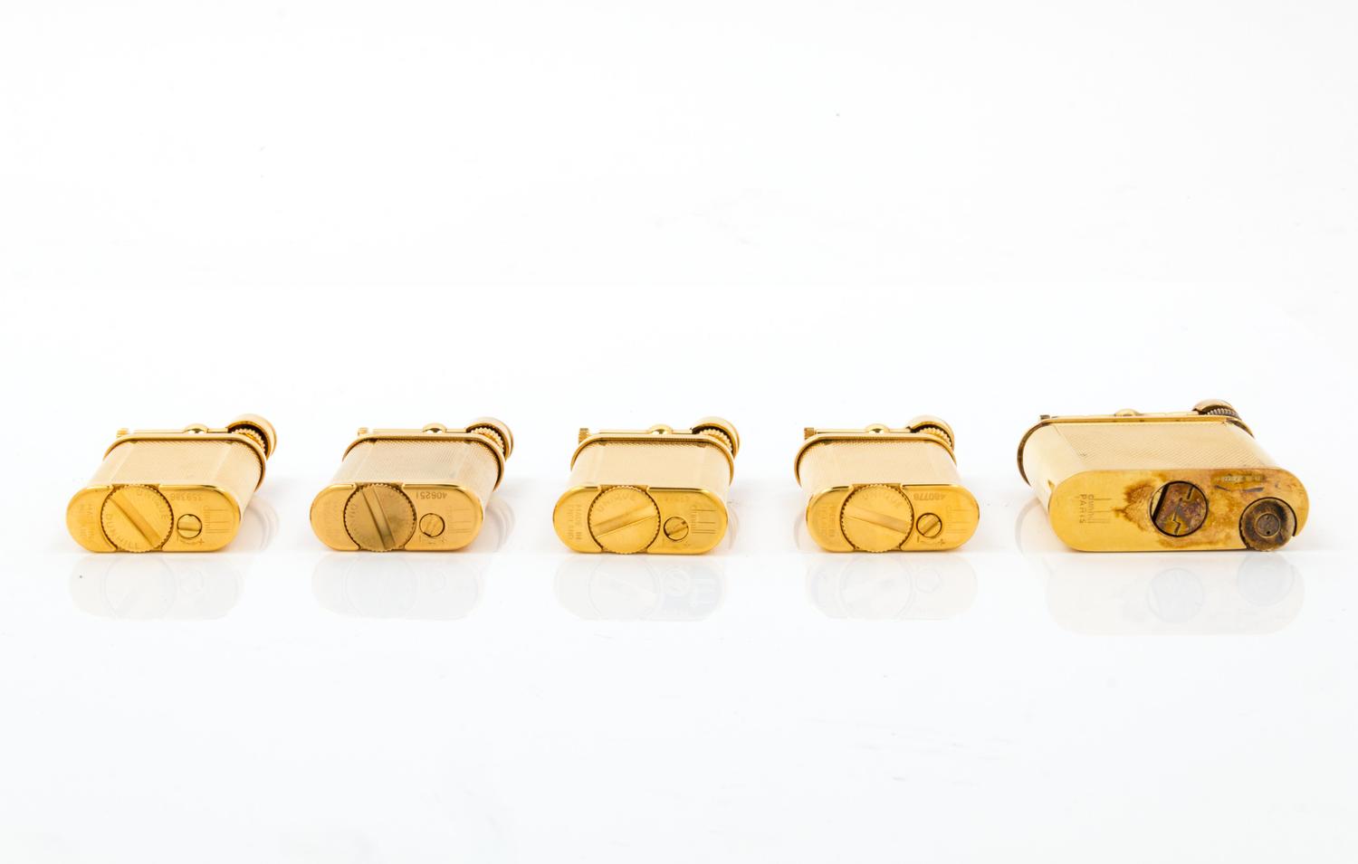 A Group of Five Gilt Metal Dunhill Lift-Arm Lighters