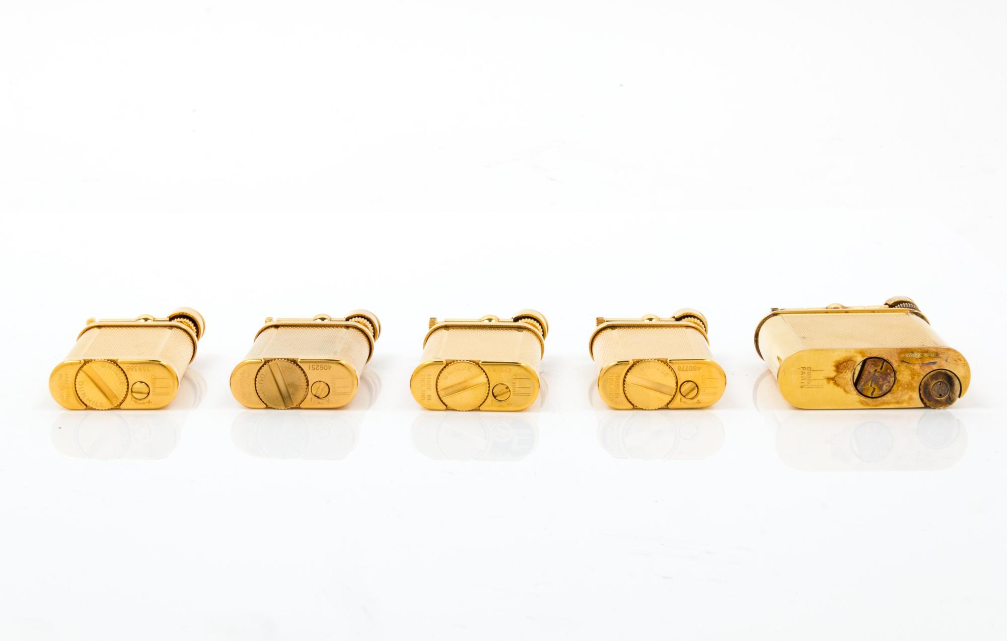 A Group of Five Gilt Metal Dunhill Lift-Arm Lighters