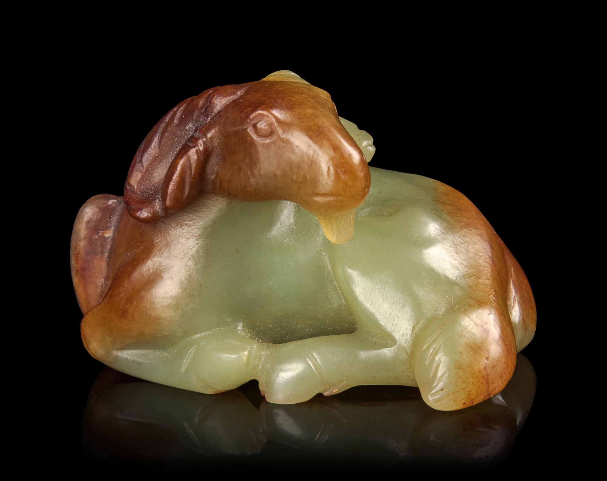 A Russet and White Jade Figure of a Ram