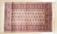 A Bokhara Wool Rug 5 feet 3/4 inches x 3 feet 2 inches.