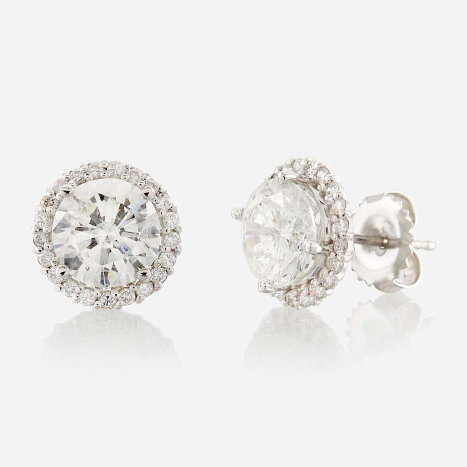 A pair of diamond and gold earrings
