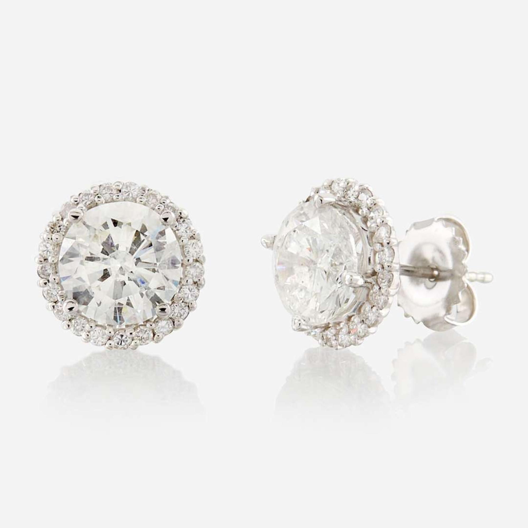 A pair of diamond and gold earrings