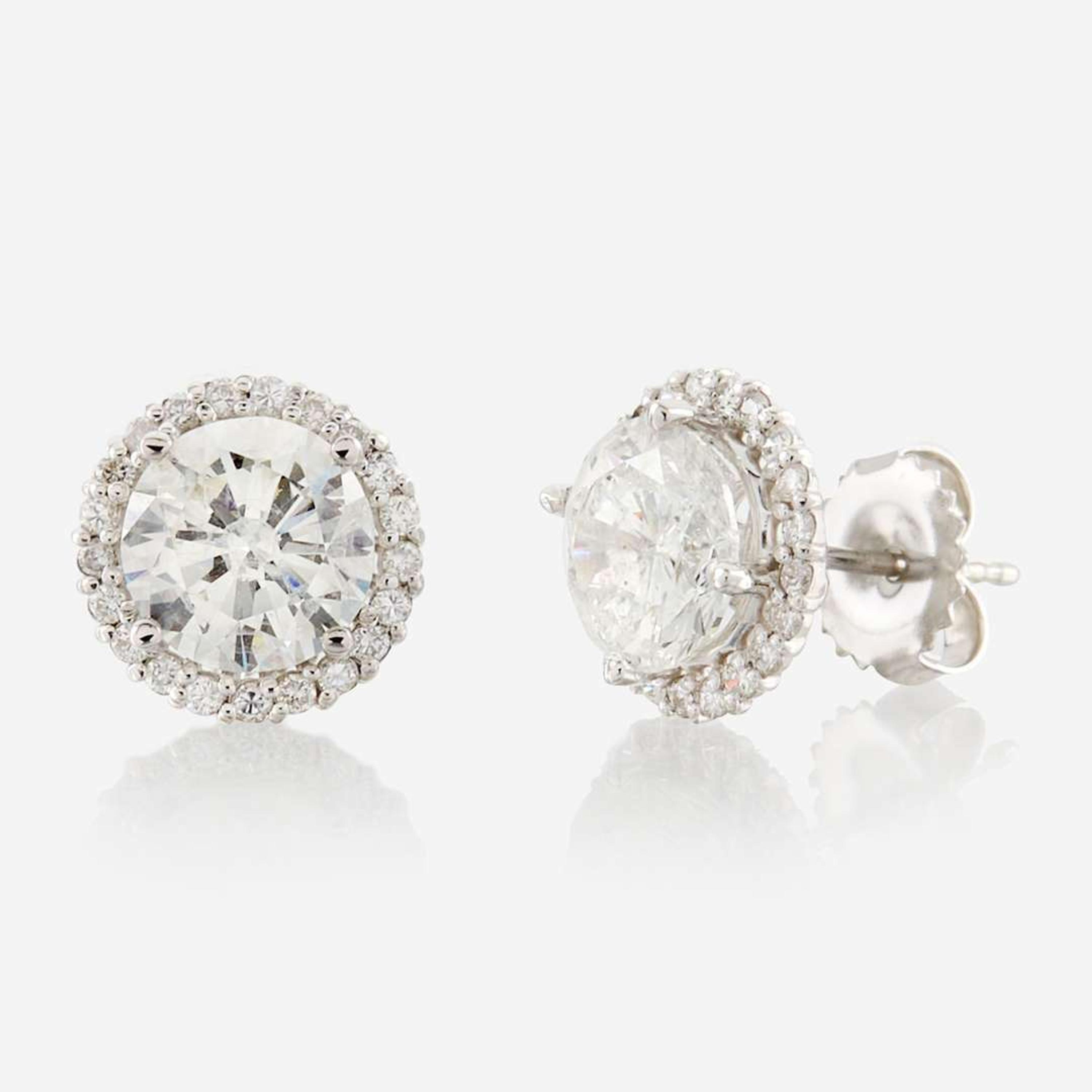 A pair of diamond and gold earrings