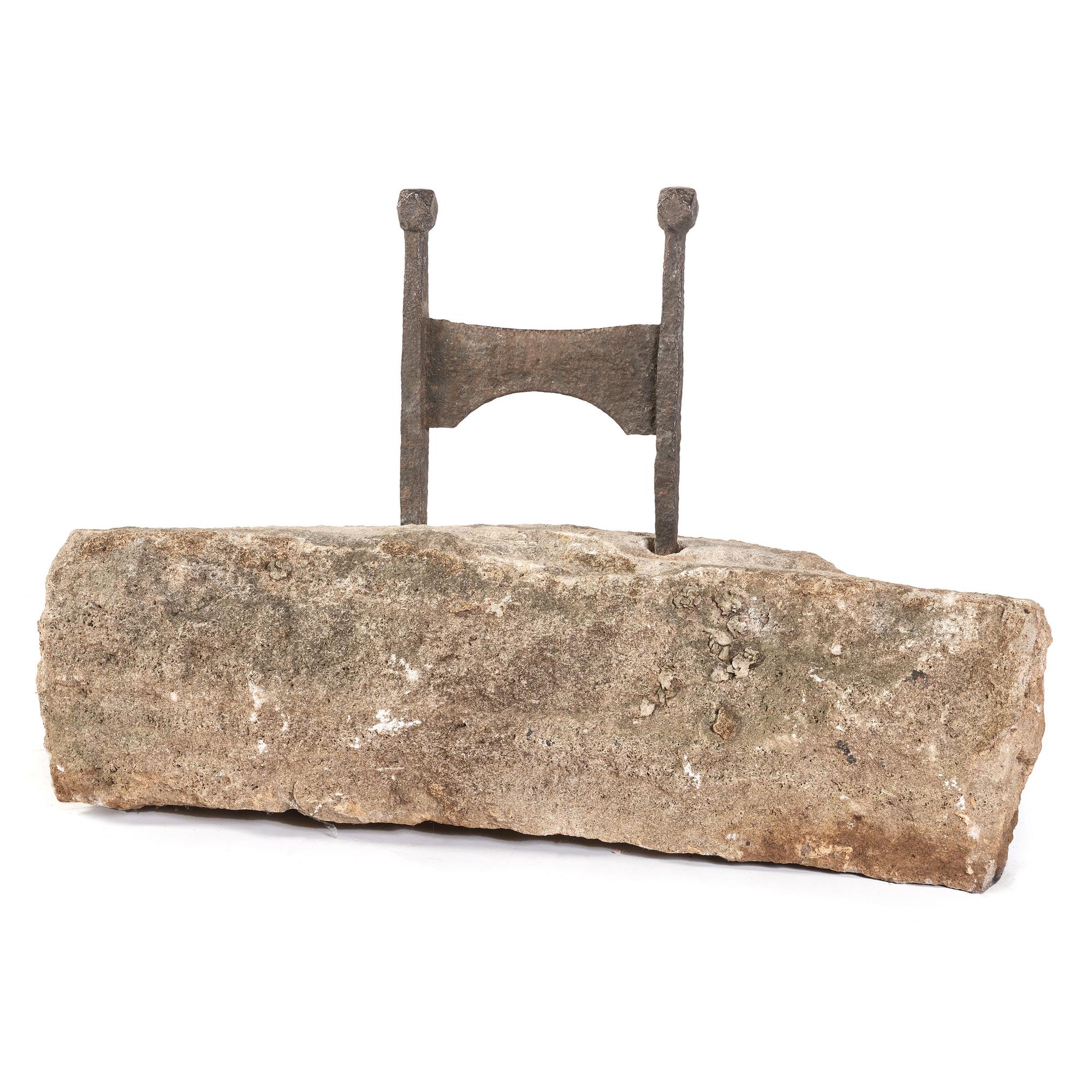 A Wrought Iron Boot Scrape with Limestone Base