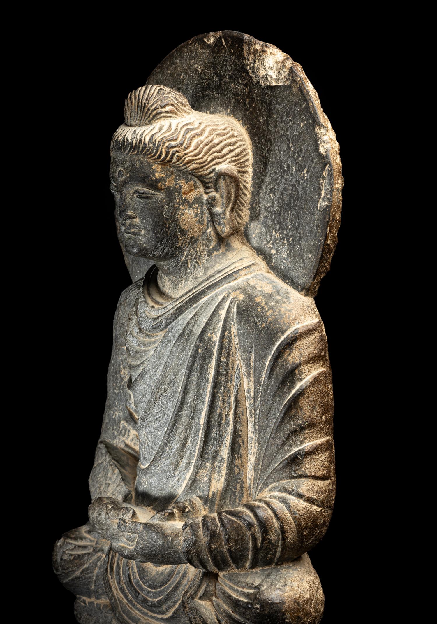 A Gandharan Grey Schist Figure of Seated Buddha