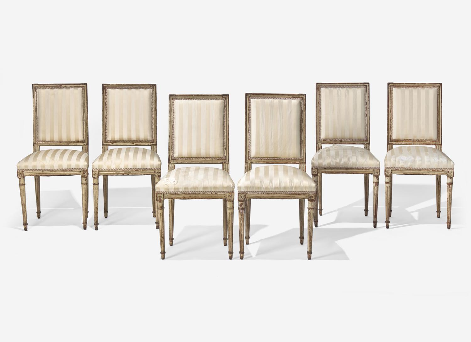 A Set of Six Louis XVI Cream-Painted and Parcel Gilt Dining Chairs