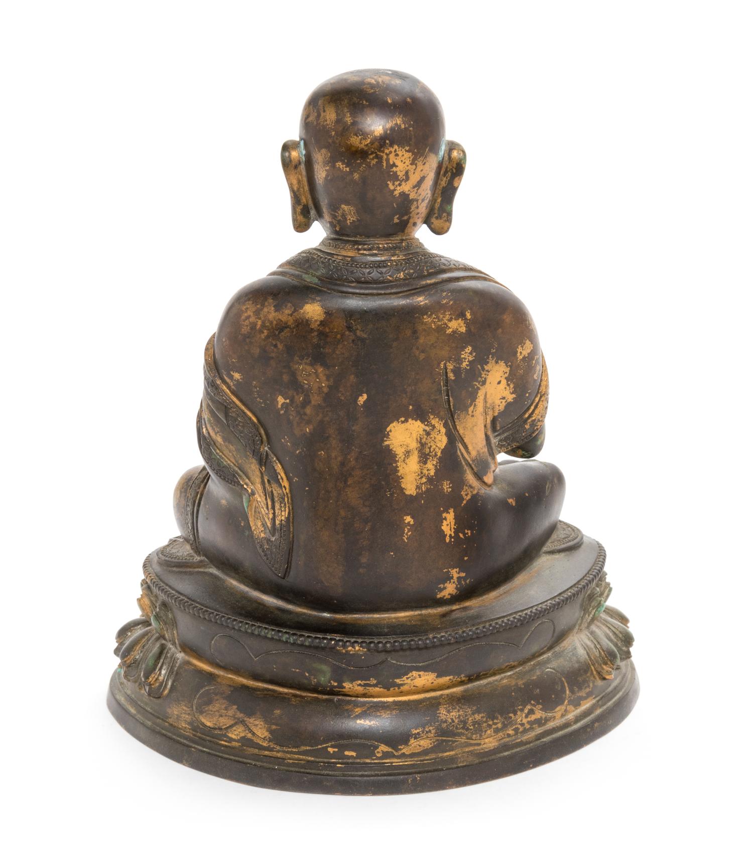 A Sino-Tibetan Parcel Gilt Bronze Figure of Guru Height 8 inches. — MING DYNASTY (1368-1644)