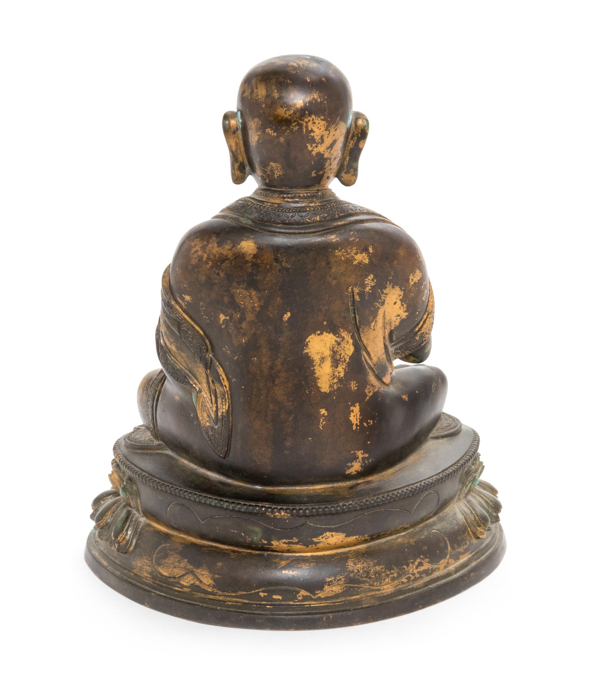 A Sino-Tibetan Parcel Gilt Bronze Figure of Guru Height 8 inches. — MING DYNASTY (1368-1644)