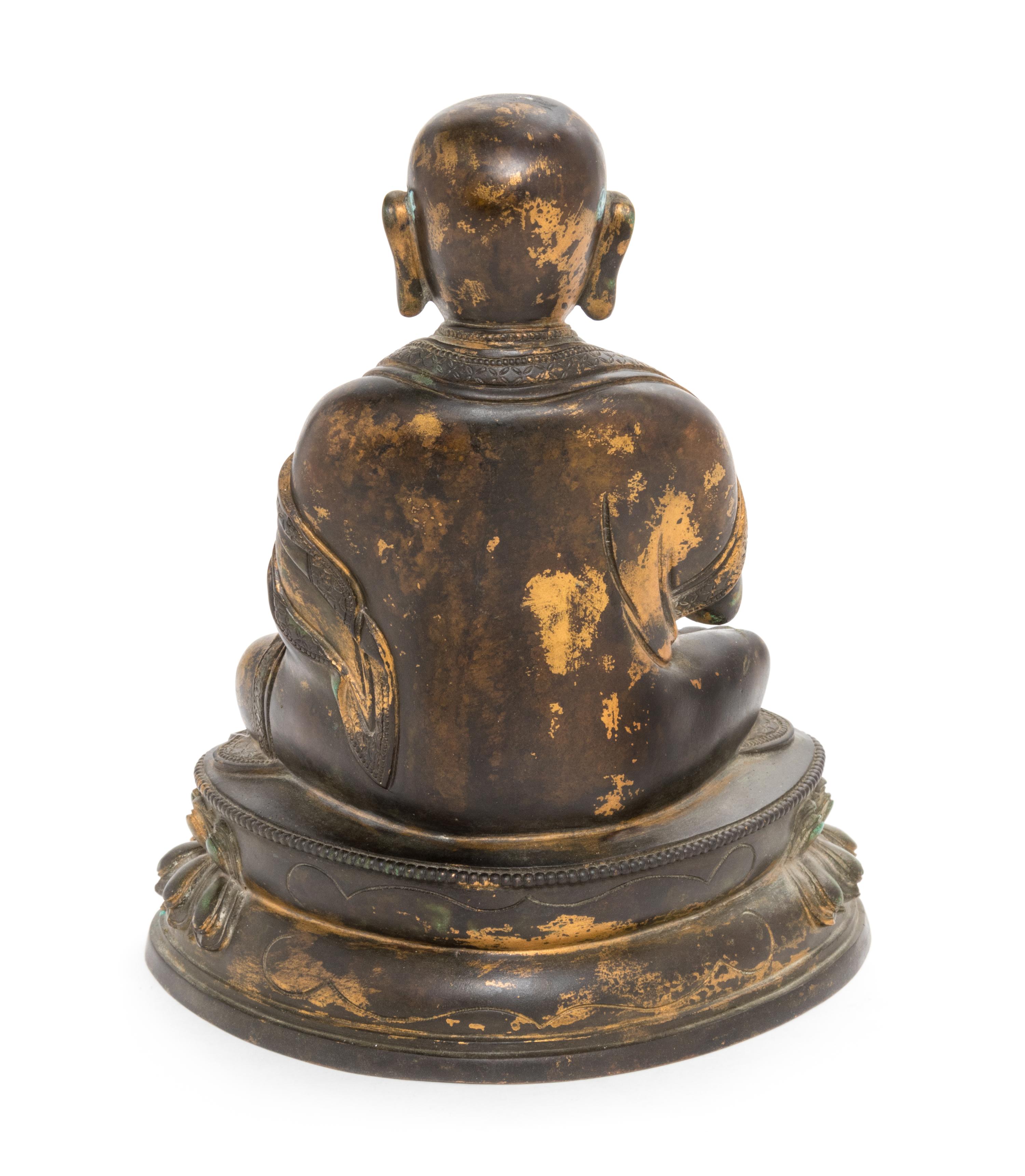 A Sino-Tibetan Parcel Gilt Bronze Figure of Guru Height 8 inches. — MING DYNASTY (1368-1644)