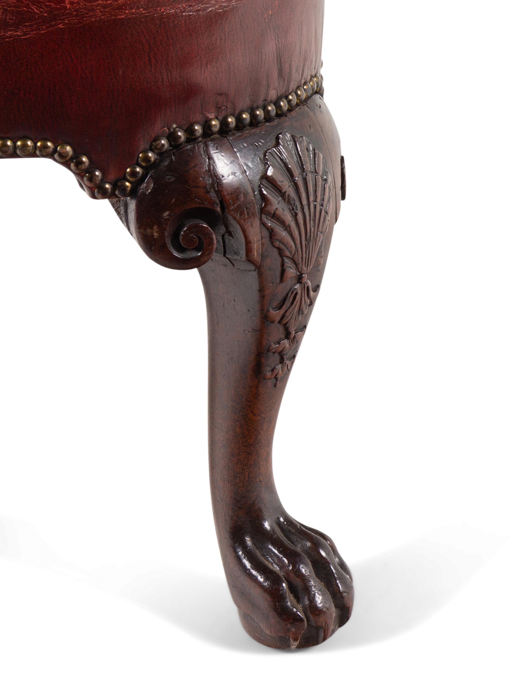 A George II Leather-Upholstered Carved Mahogany Library Chair