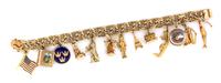 A 14 Karat Yellow Gold Charm Bracelet with 13 Attached Charms, 41.10 dwts.
