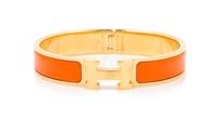 An Hermes Orange Enamel Clic Clac PM Bracelet, 6.5" x .5".