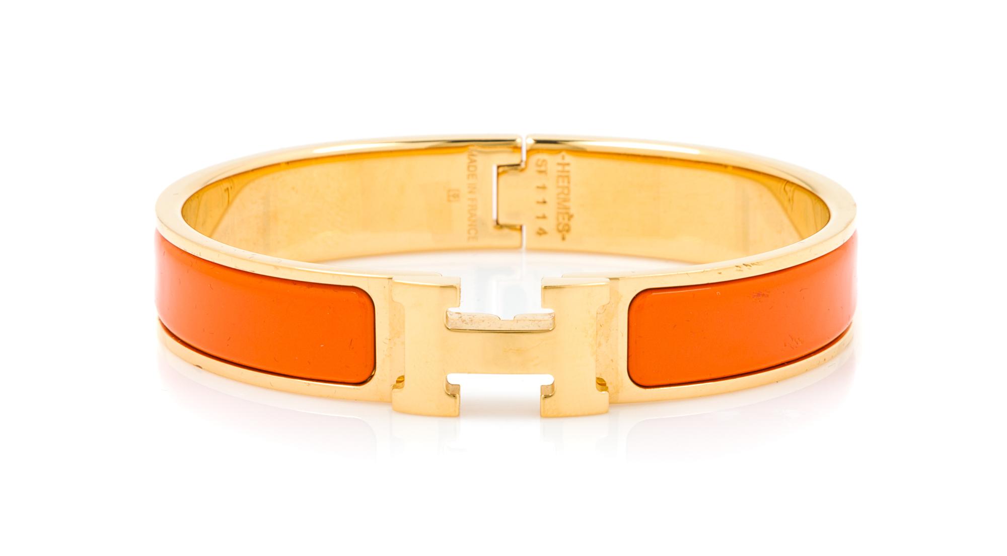 An Hermes Orange Enamel Clic Clac PM Bracelet, 6.5" x .5".