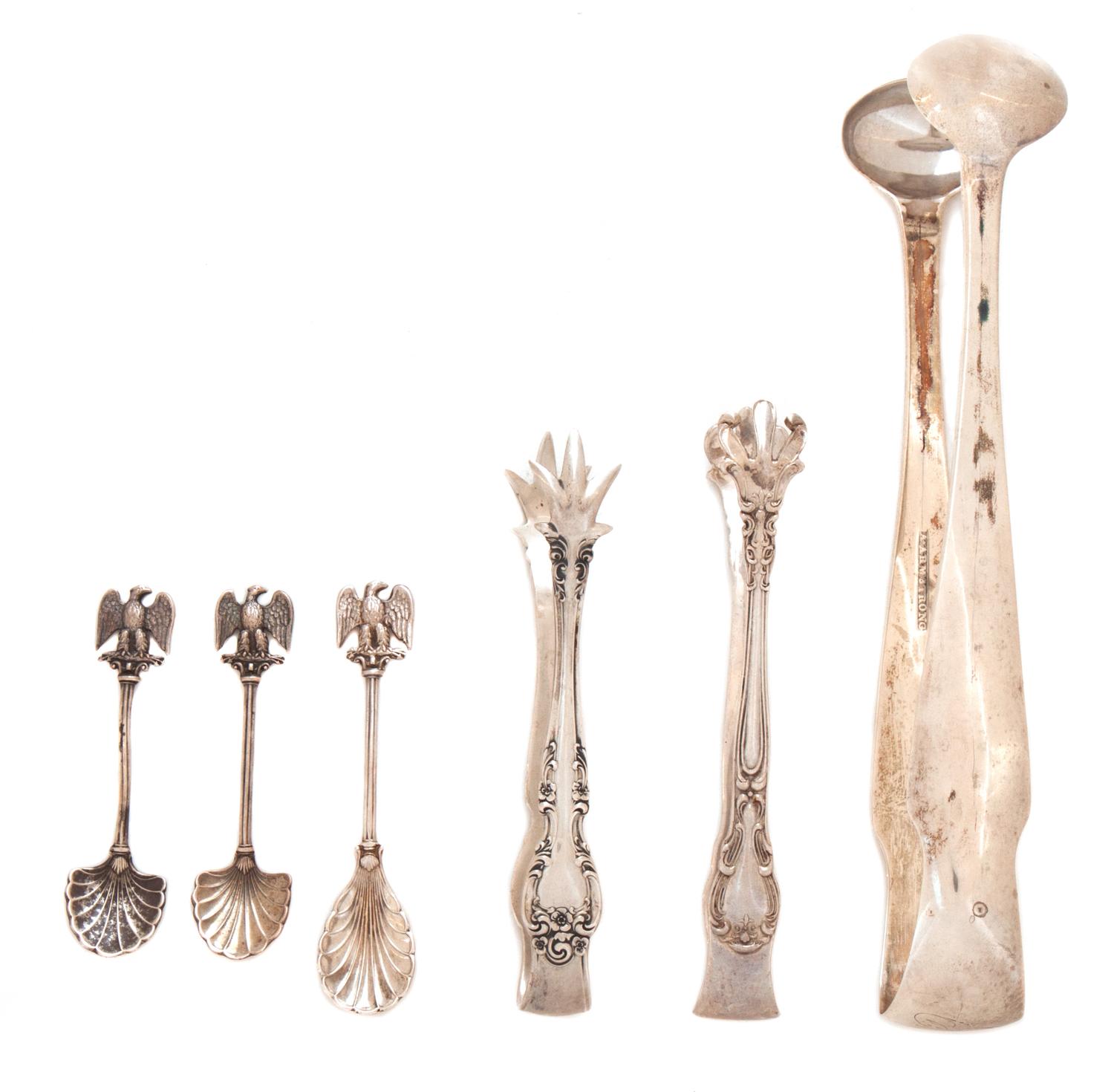 An Assembled Group of Silver Tongs and Condiment Spoons, Various Makers, including three salt spoons, two sugar cube tongs, and an ice