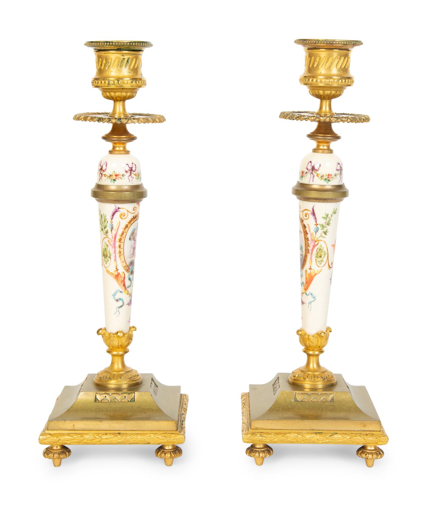 A Pair of French Gilt Bronze and Painted Porcelain Candlesticks