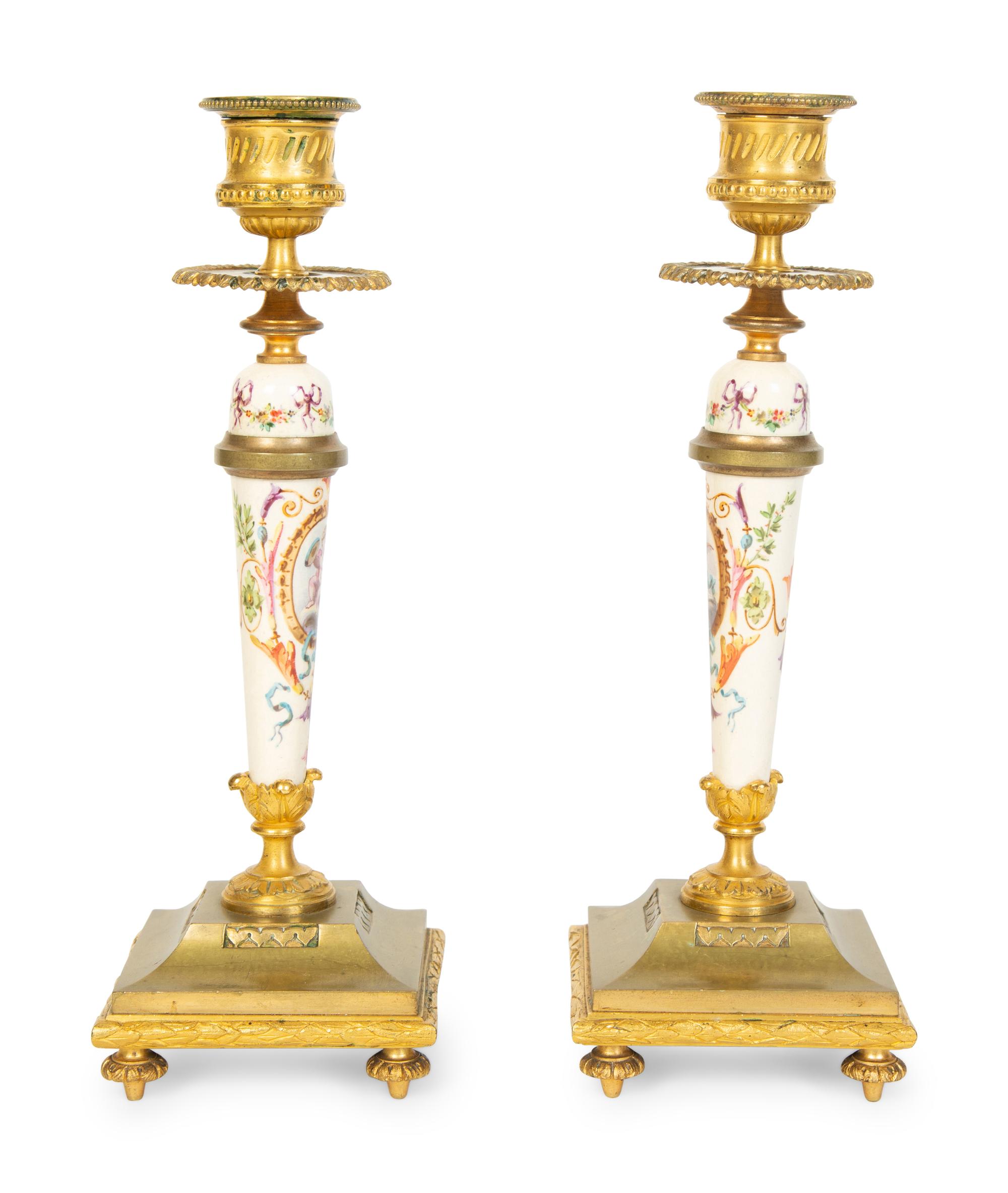 A Pair of French Gilt Bronze and Painted Porcelain Candlesticks