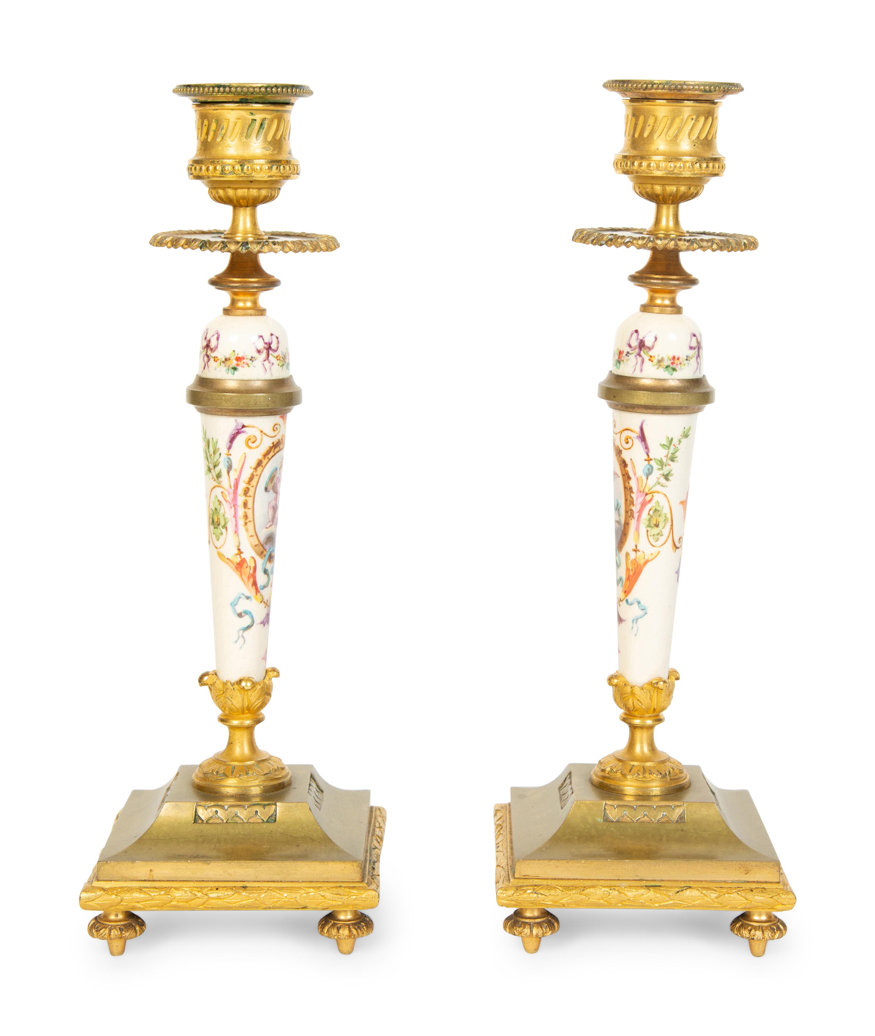 A Pair of French Gilt Bronze and Painted Porcelain Candlesticks