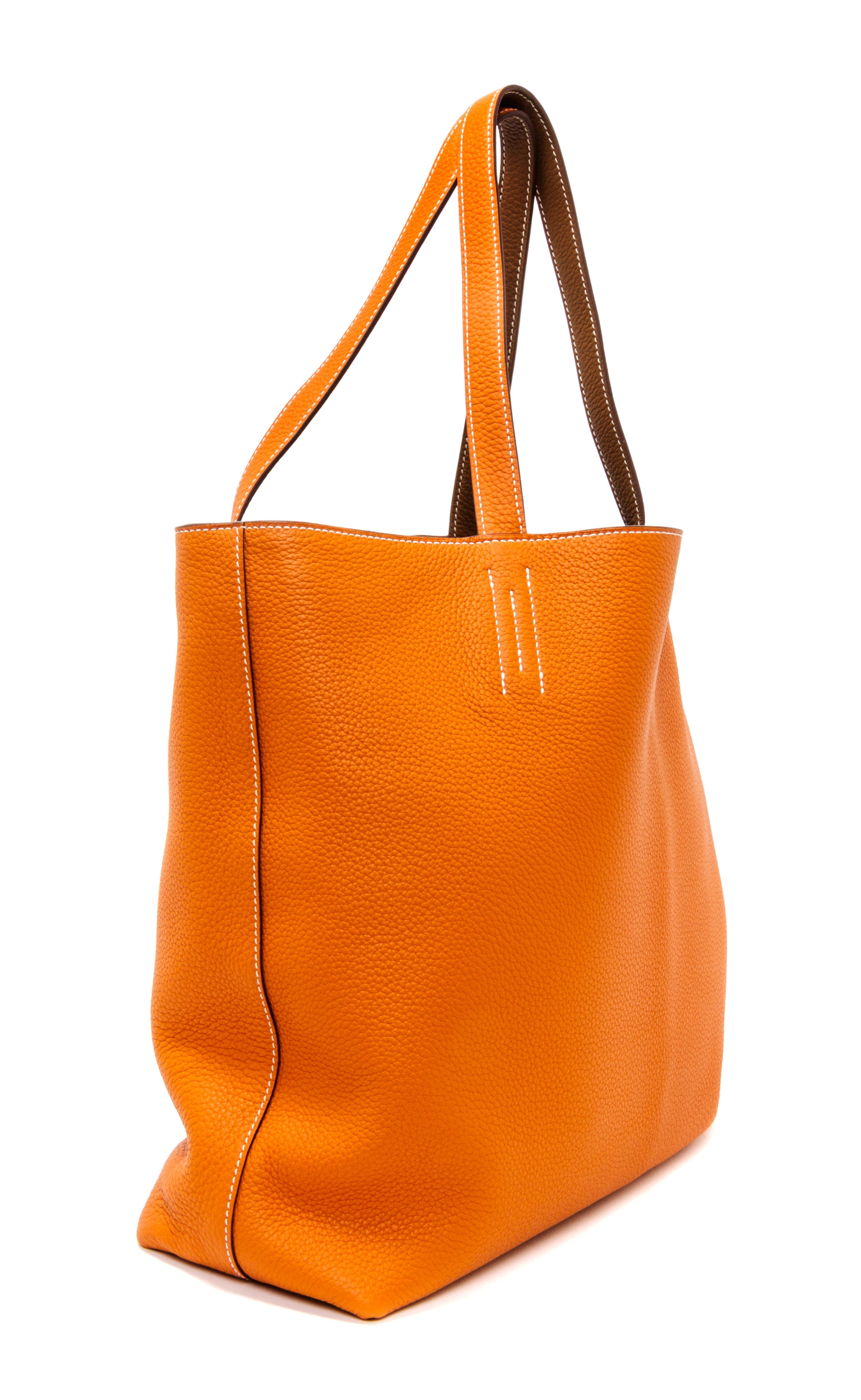 An Hermes Orange/Gold 45cm Taurillon Clemence Double Sens Tote, 17.5" x 15.5" x 5".