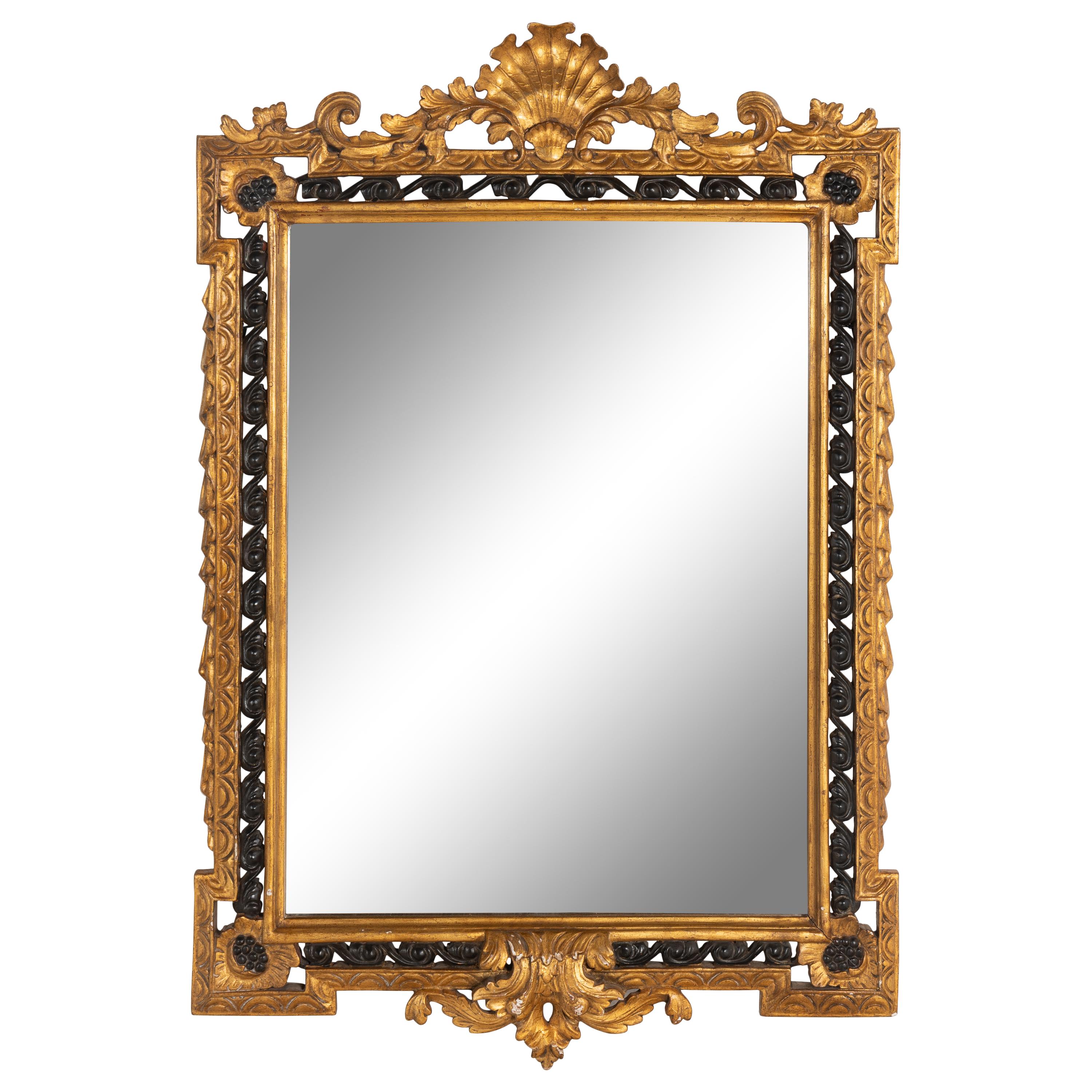 An Italian Giltwood and Part Ebonized Mirror