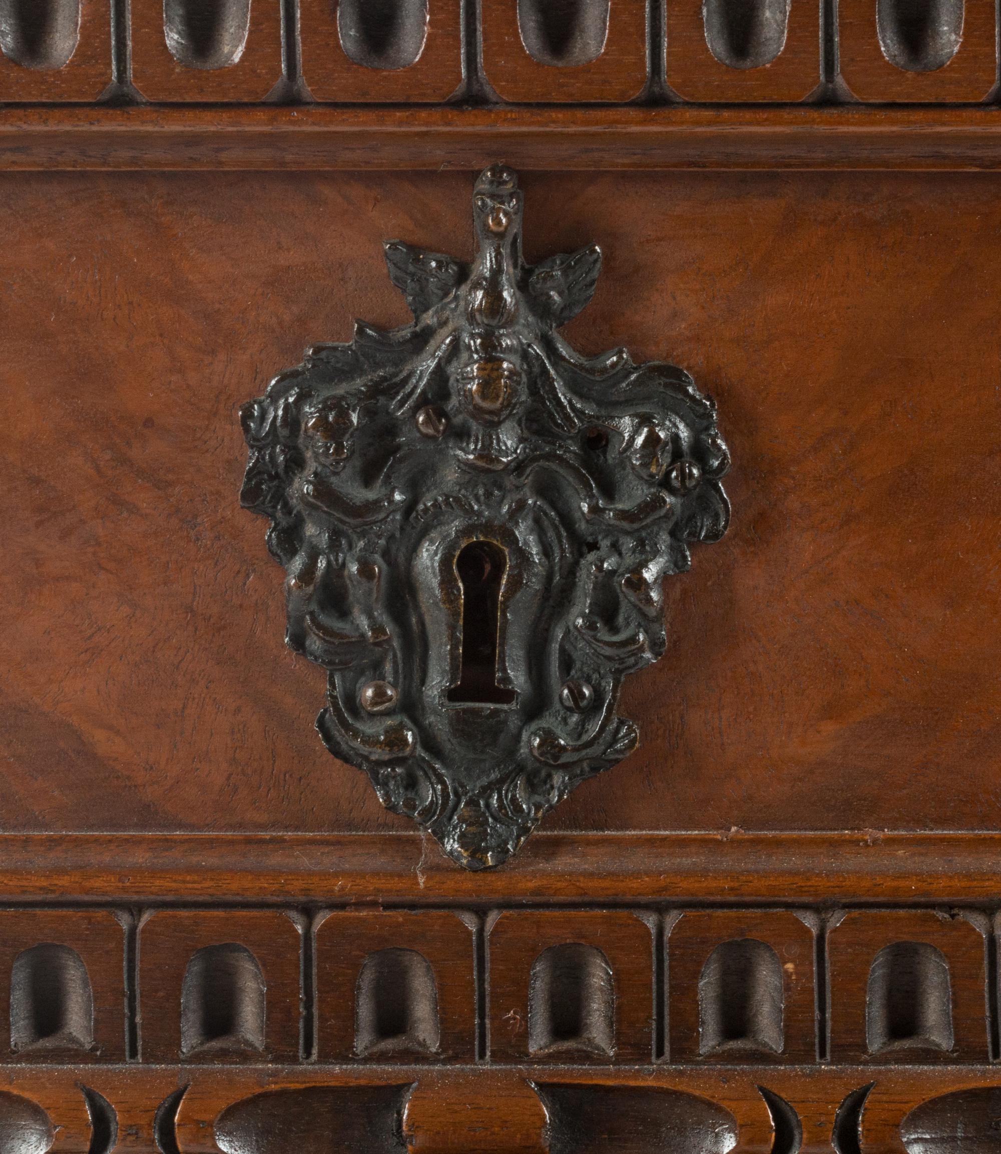 An Italian Renaissance Revival Carved Walnut Chest of Drawers