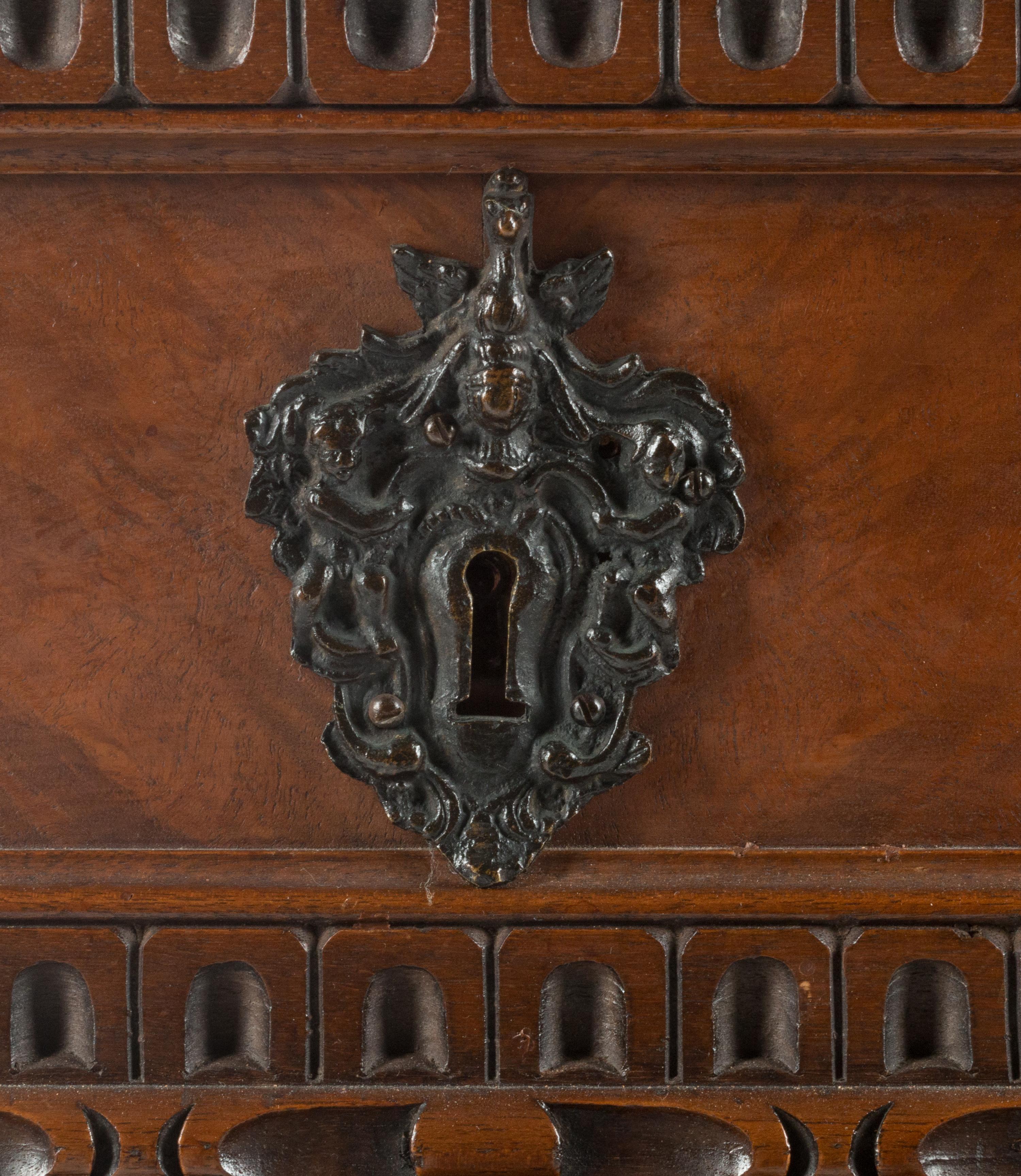 An Italian Renaissance Revival Carved Walnut Chest of Drawers
