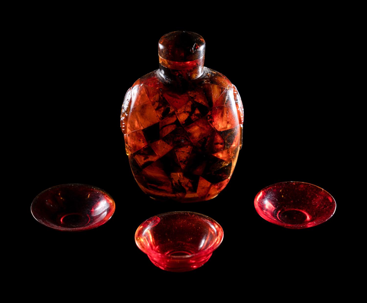 Three Chinese Red Peking Glass Snuff Dishes and A Plastic Imitating Amber Snuff Bottle