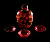 Three Chinese Red Peking Glass Snuff Dishes and A Plastic Imitating Amber Snuff Bottle