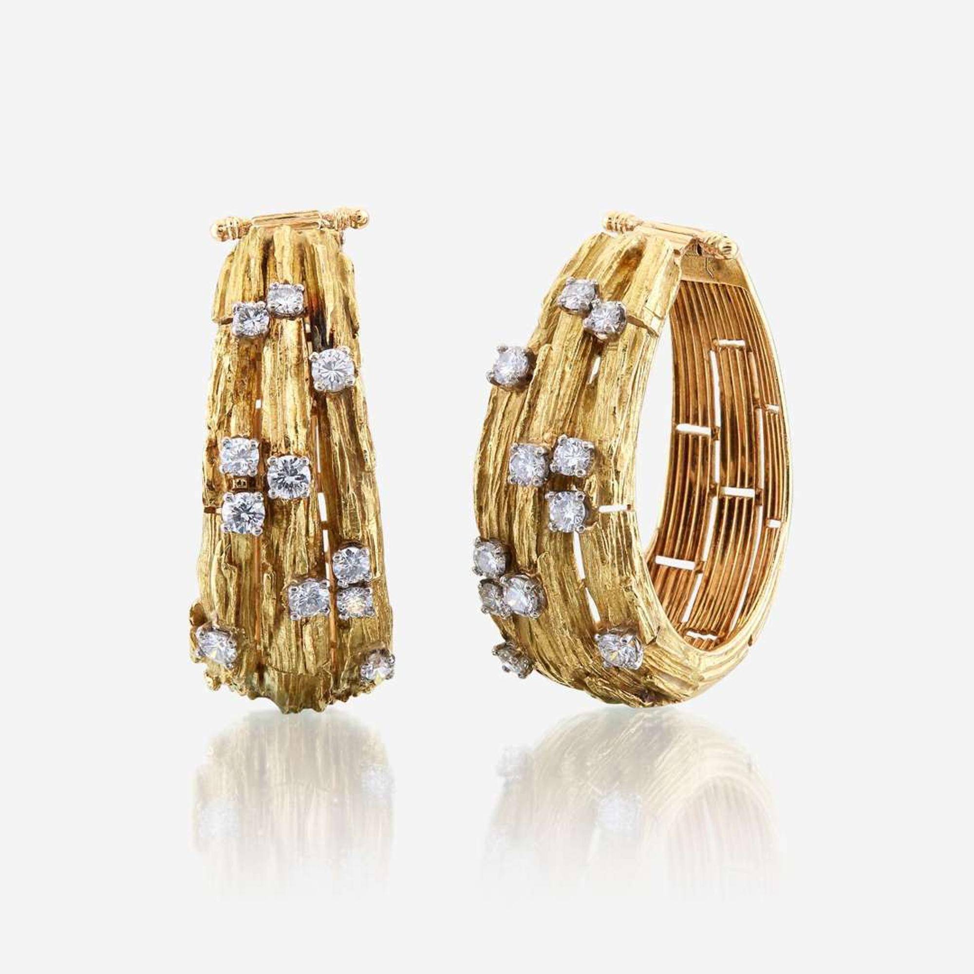 A pair of eighteen karat gold and diamond ear clips