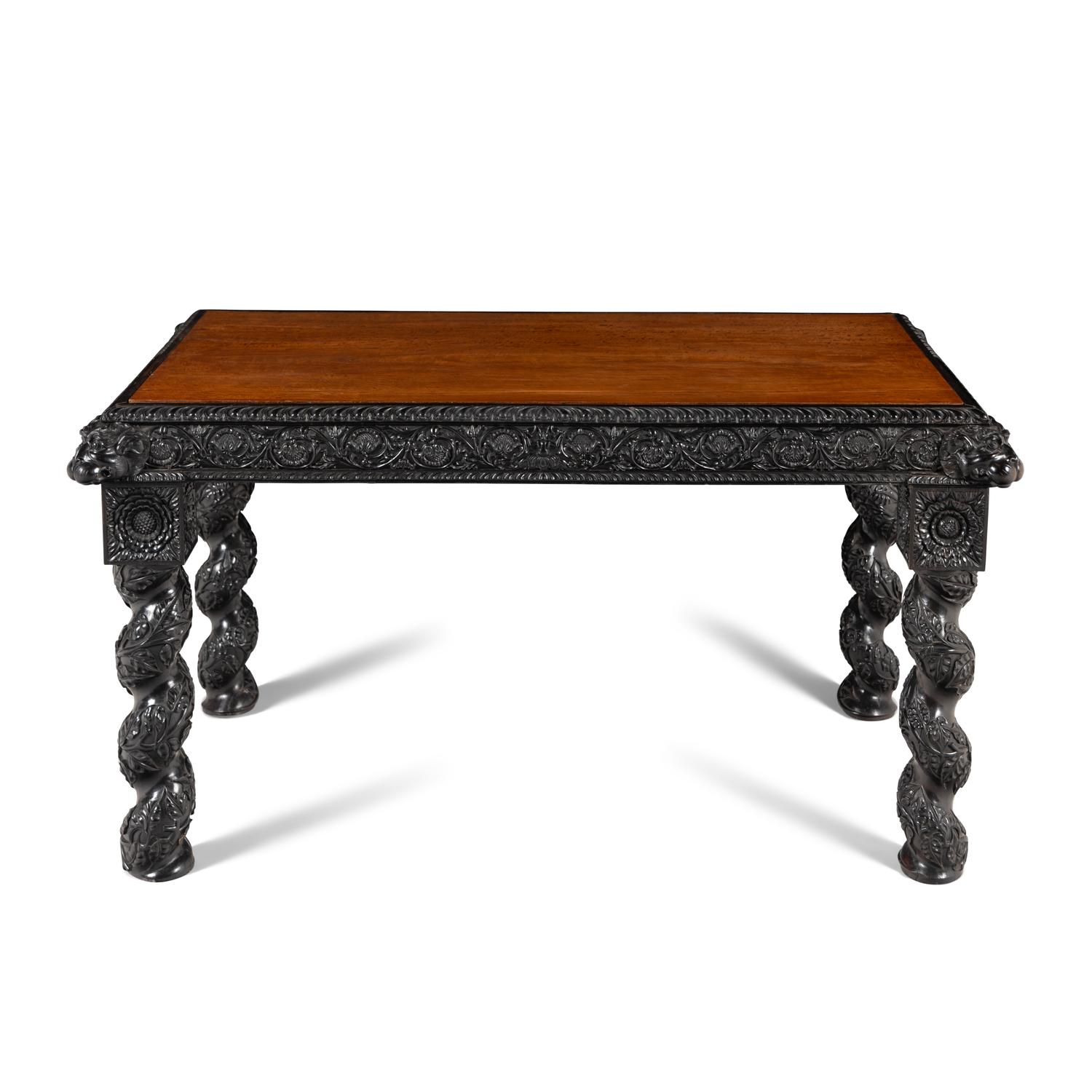 An Anglo-Colonial Carved Ebony and Satinwood Center Table