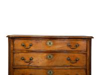 A George III Walnut Serpentine Chest of Drawers — 18TH CENTURY