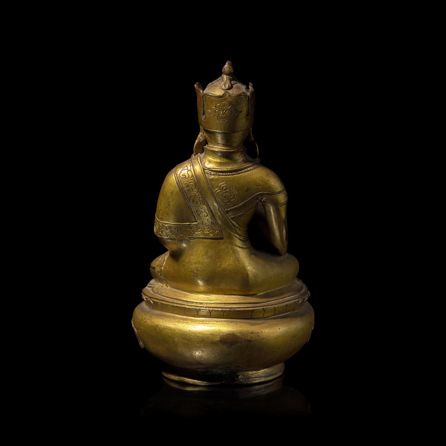 A Tibetan Gilt Copper Alloy Figure of Padmasambava, 18th/19th Century or Earlier 十八/十九世紀或更早 銅合金蓮花生坐像