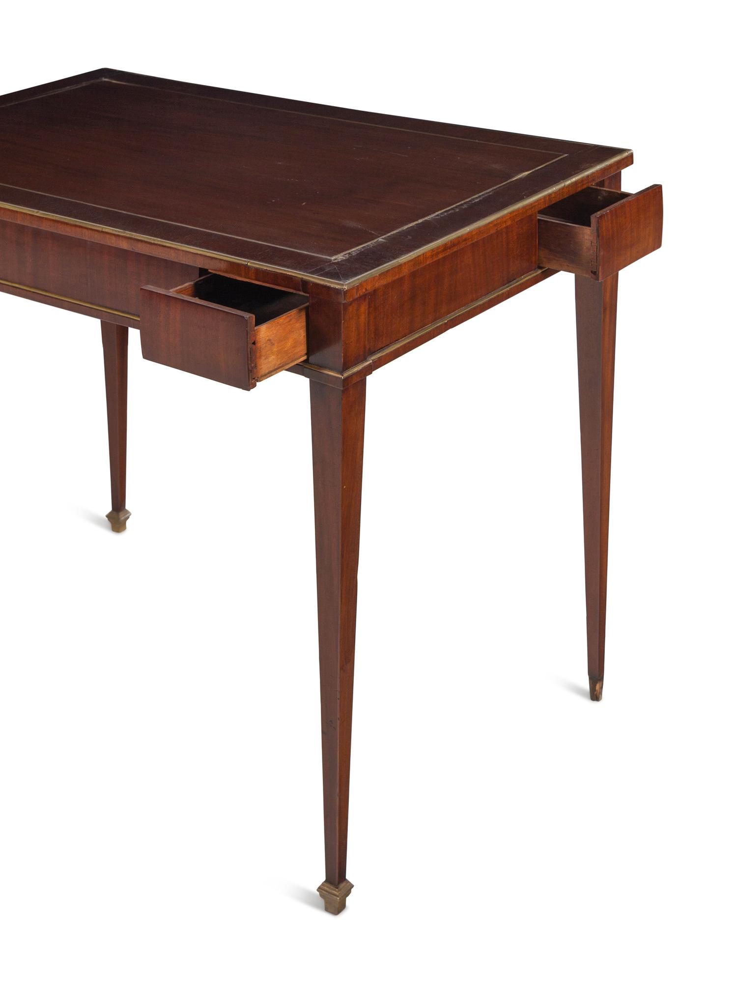 A Russian or Baltic Neoclassical Brass Mounted Mahogany Four-Drawer Table