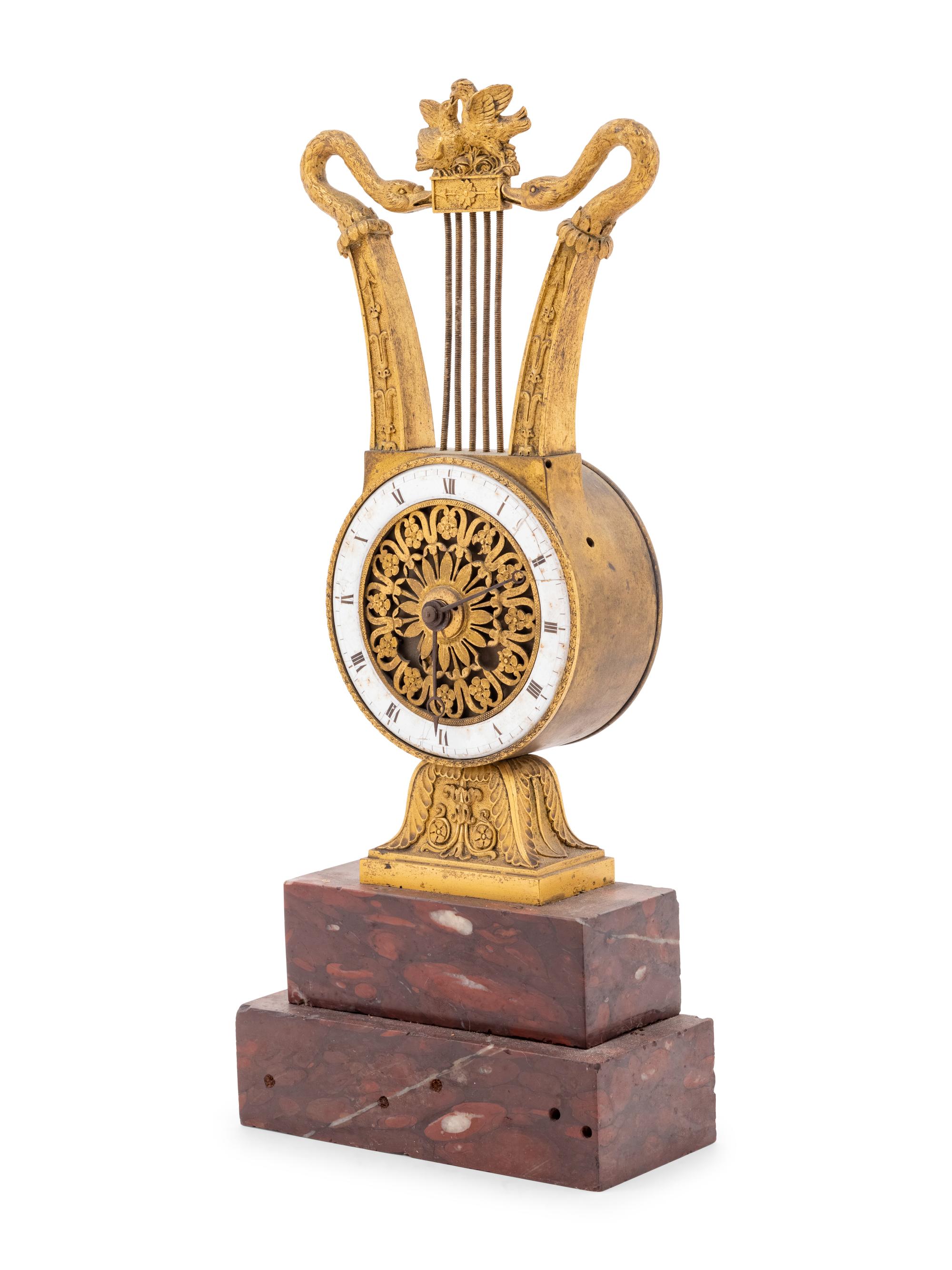 An Empire Style Gilt Bronze and Rouge Marble Clock