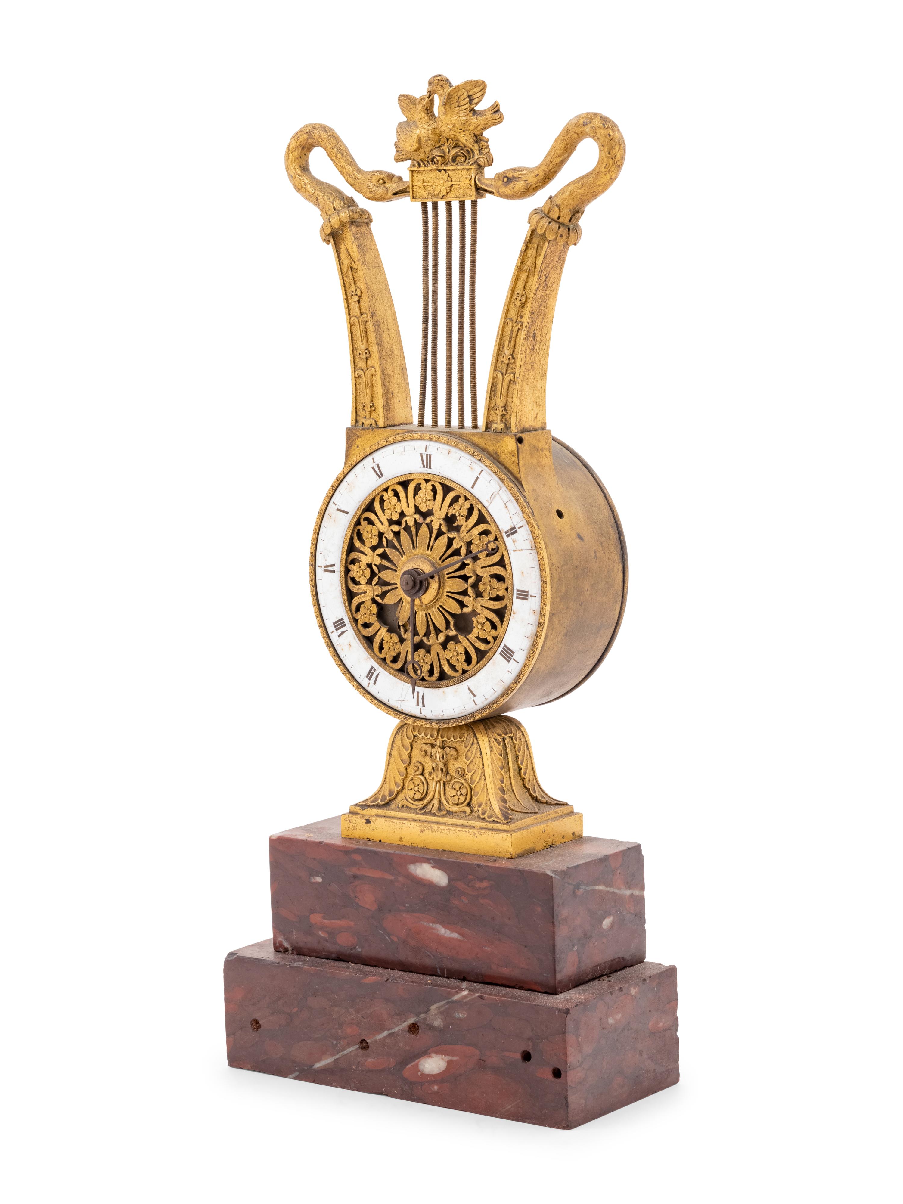 An Empire Style Gilt Bronze and Rouge Marble Clock