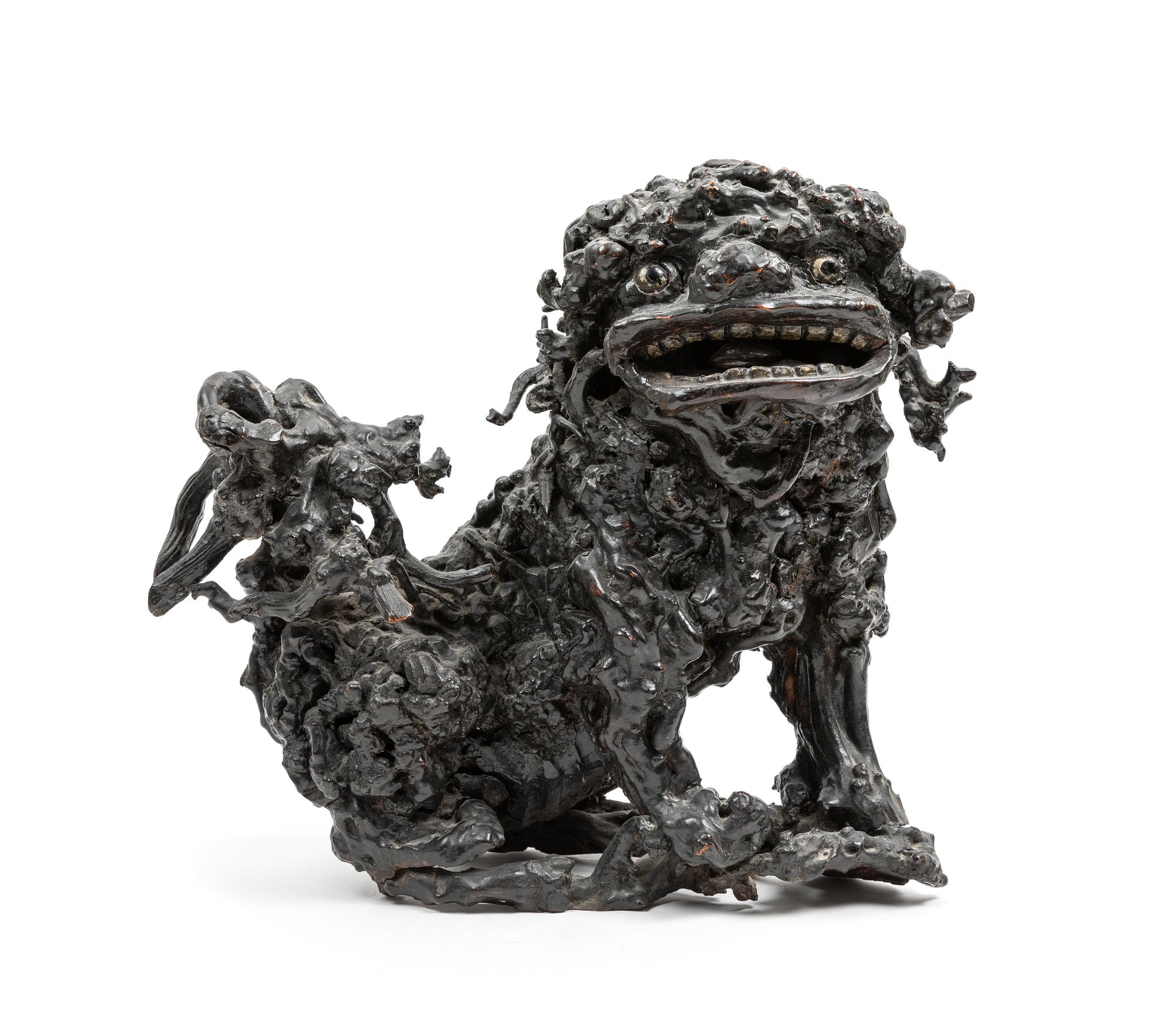 A Chinese Carved Lychee Wood Figure of a Fu Lion Height 13 1/2 inches. — 19TH CENTURY