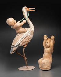 A Folk Art Carved and Painted Wood Figural Group of a Stork and Two Babies