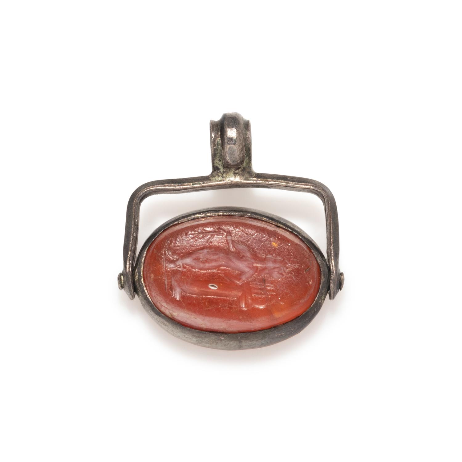 A Roman Carnelian Scaraboid with a Muse — Set in a silver swivel pendant