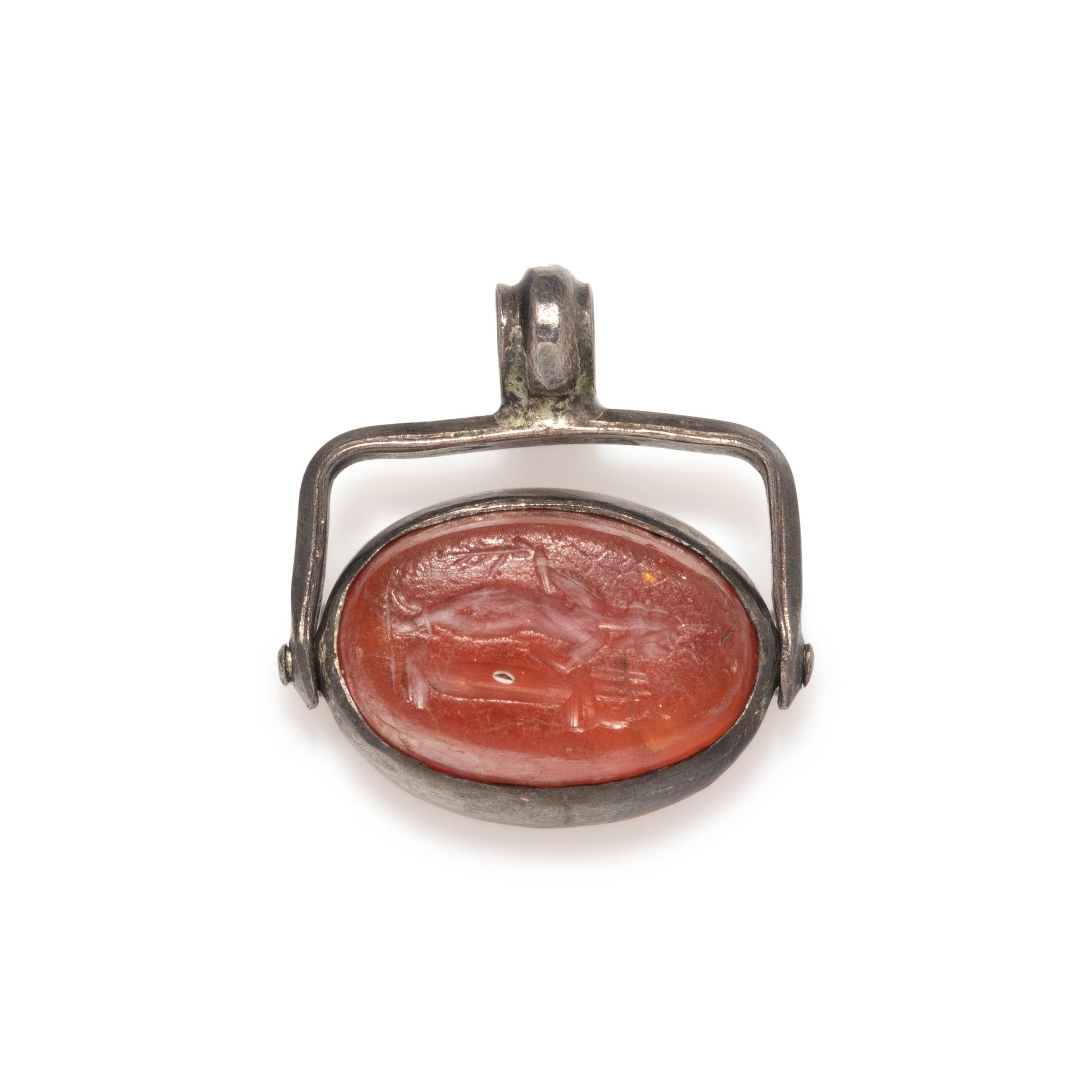 A Roman Carnelian Scaraboid with a Muse — Set in a silver swivel pendant