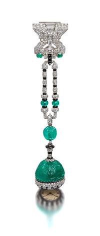 An Art Deco Platinum, Emerald, Diamond, Onyx and Enamel Lapel Watch, Cartier, 37.00 dwts.