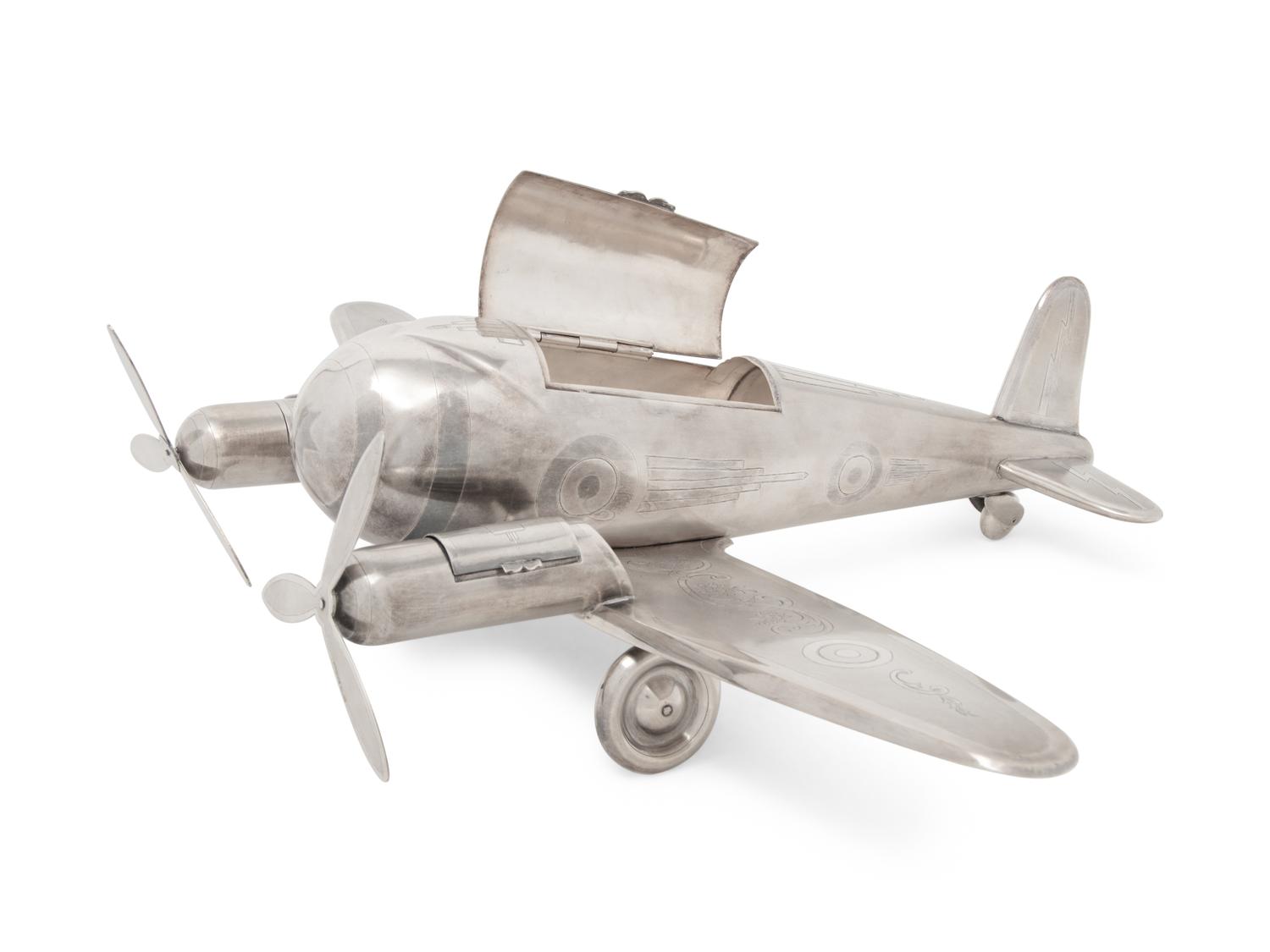 A Large Silvered Metal Airplane-Form Table Top Smoking Set