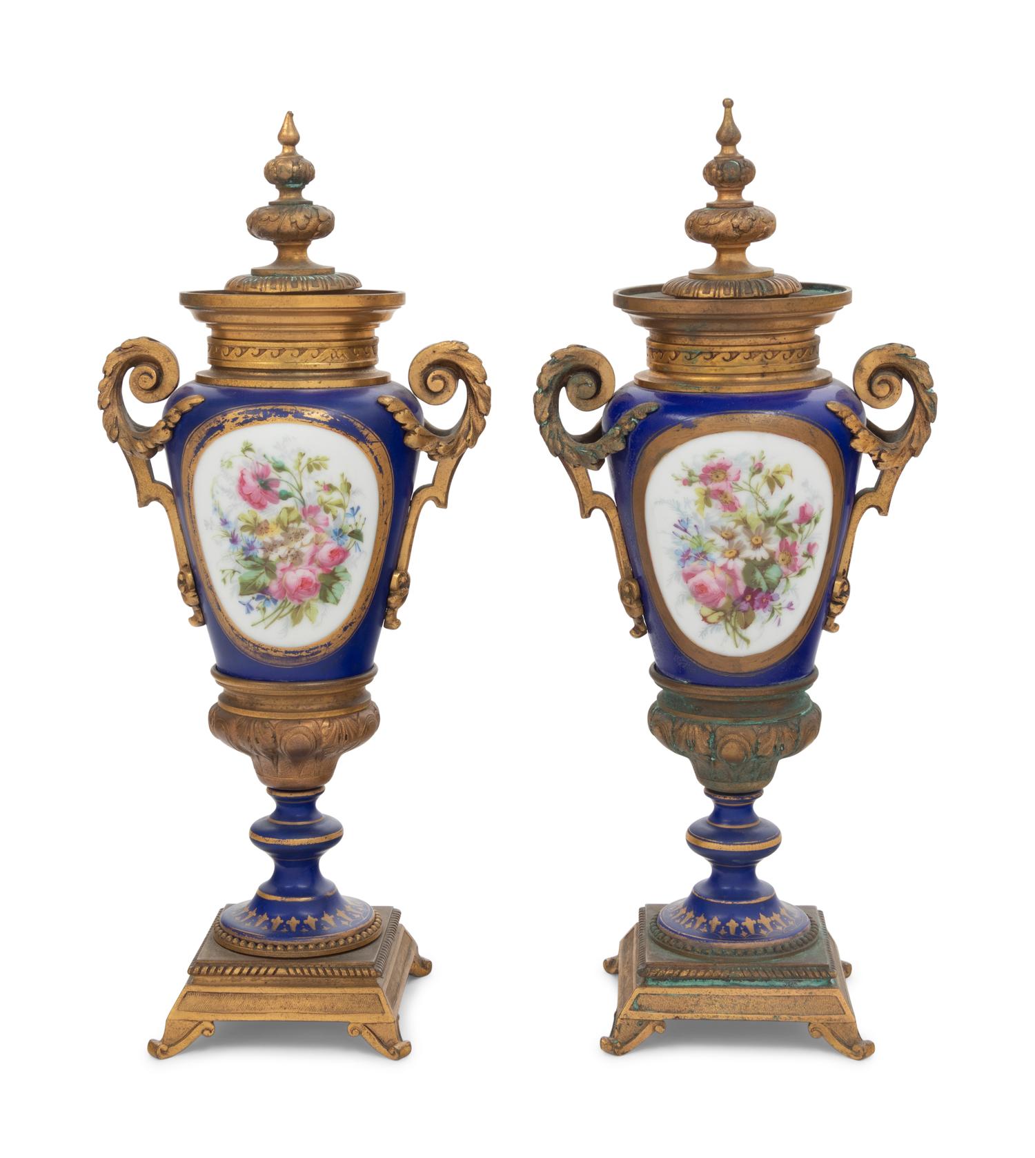 A Pair of Sèvres Style Gilt Bronze Mounted Porcelain Urns
