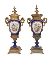 A Pair of Sèvres Style Gilt Bronze Mounted Porcelain Urns